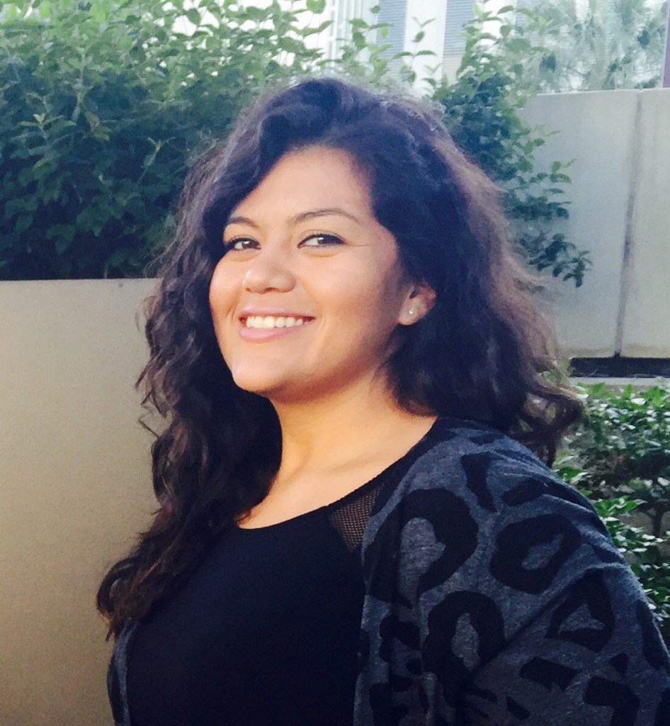 A woman with dark hair smiles at the camera.